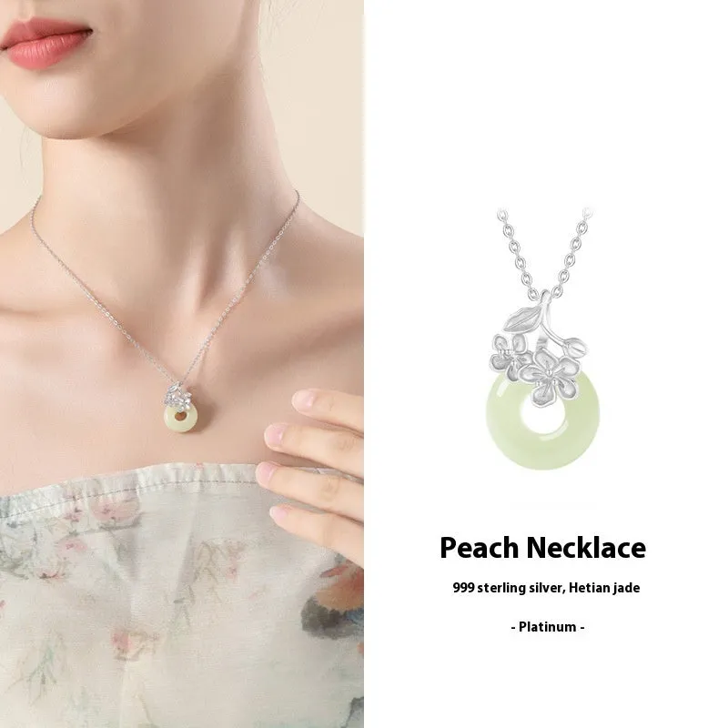Silver pendant necklace with a peace buckle design on an adjustable cross chain.