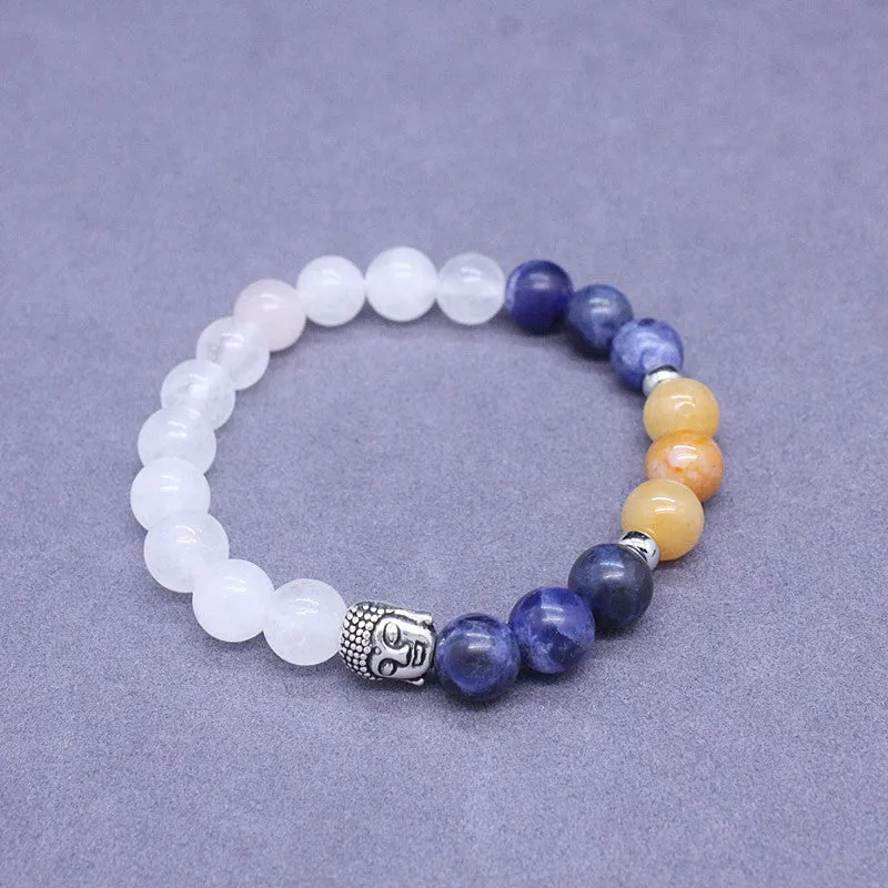 Natural stone elastic bracelet in a mixed colour pattern on a wrist.