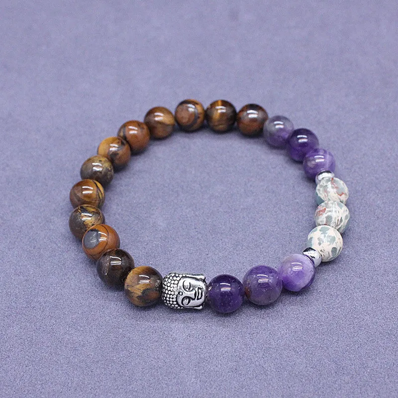Natural stone elastic bracelet in a mixed colour pattern on a wrist.