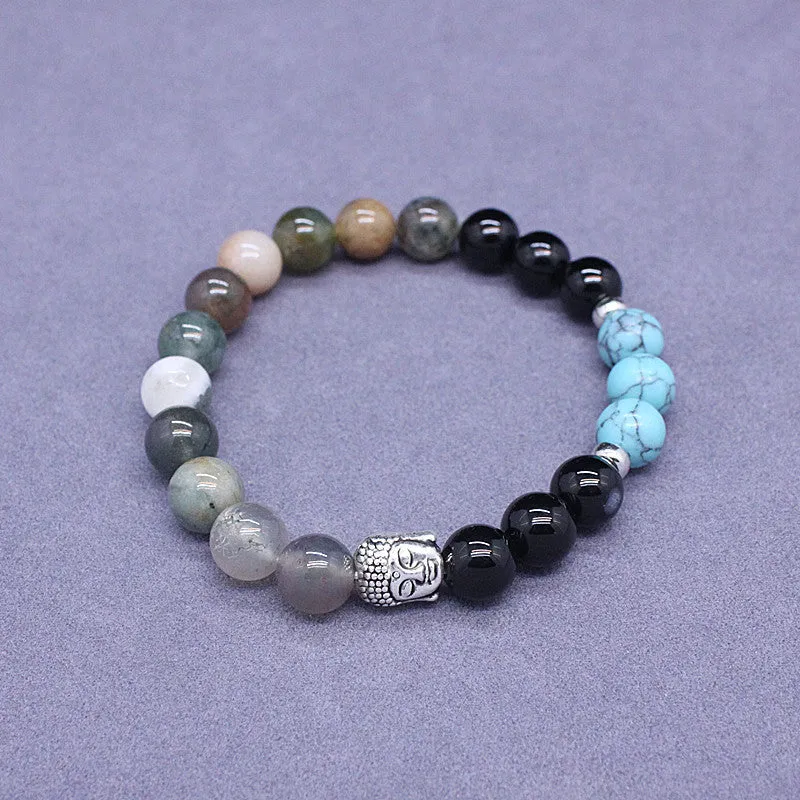 Natural stone elastic bracelet in a mixed colour pattern on a wrist.