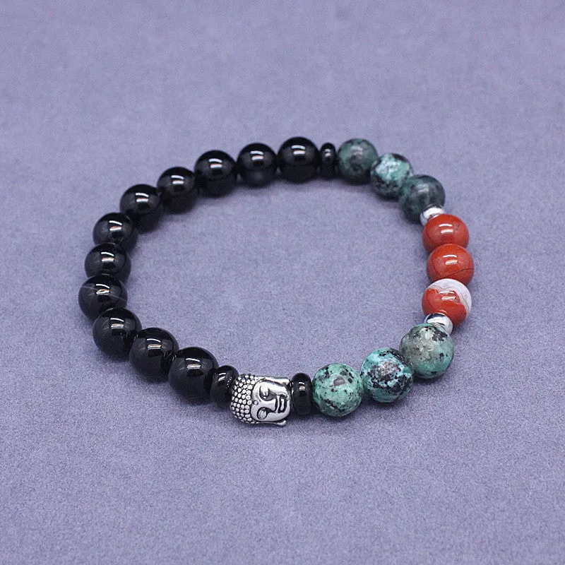 Natural stone elastic bracelet in a mixed colour pattern on a wrist.