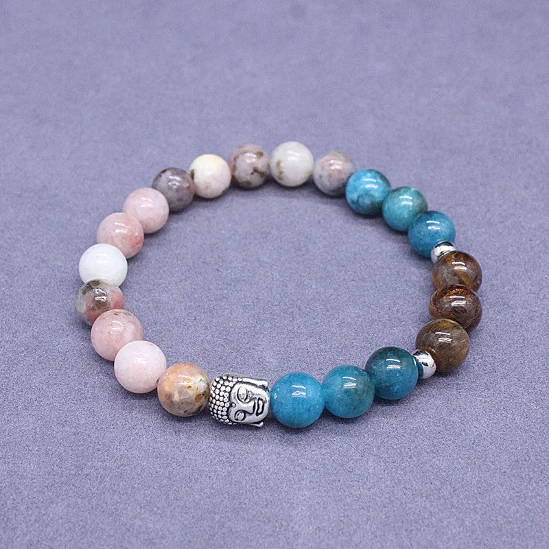 Natural stone elastic bracelet in a mixed colour pattern on a wrist.