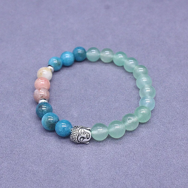 Natural stone elastic bracelet in a mixed colour pattern on a wrist.
