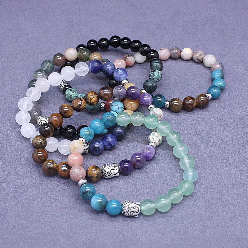 Natural stone elastic bracelet in a mixed colour pattern on a wrist.