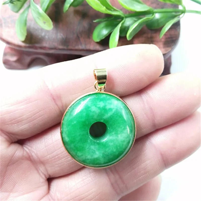 Emerald round jade pendant with gold inlaid safety buckle, modern simple geometry style, on a neutral background