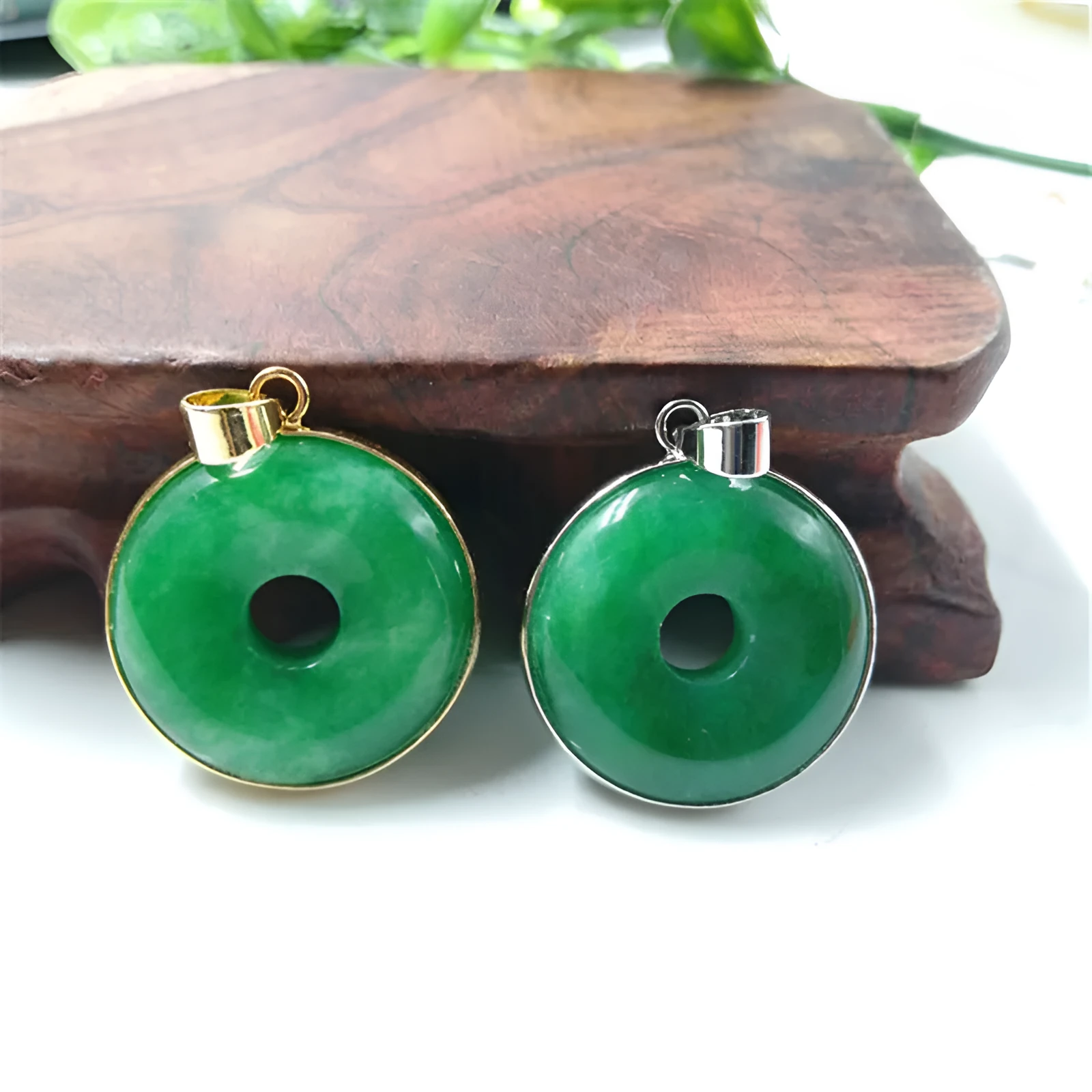 Emerald round jade pendant with gold inlaid safety buckle, modern simple geometry style, on a neutral background