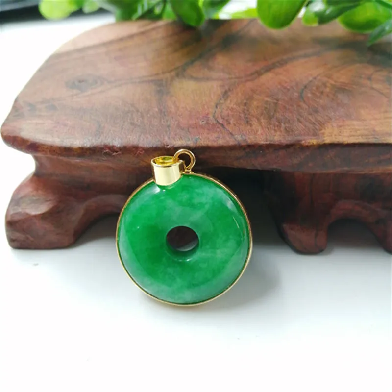 Emerald round jade pendant with gold inlaid safety buckle, modern simple geometry style, on a neutral background