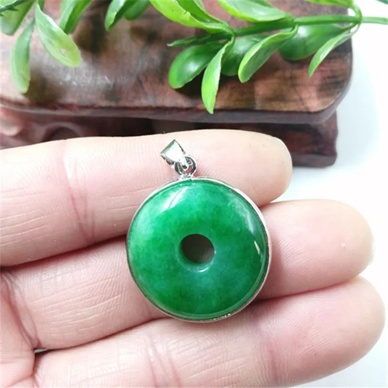 Emerald round jade pendant with gold inlaid safety buckle, modern simple geometry style, on a neutral background