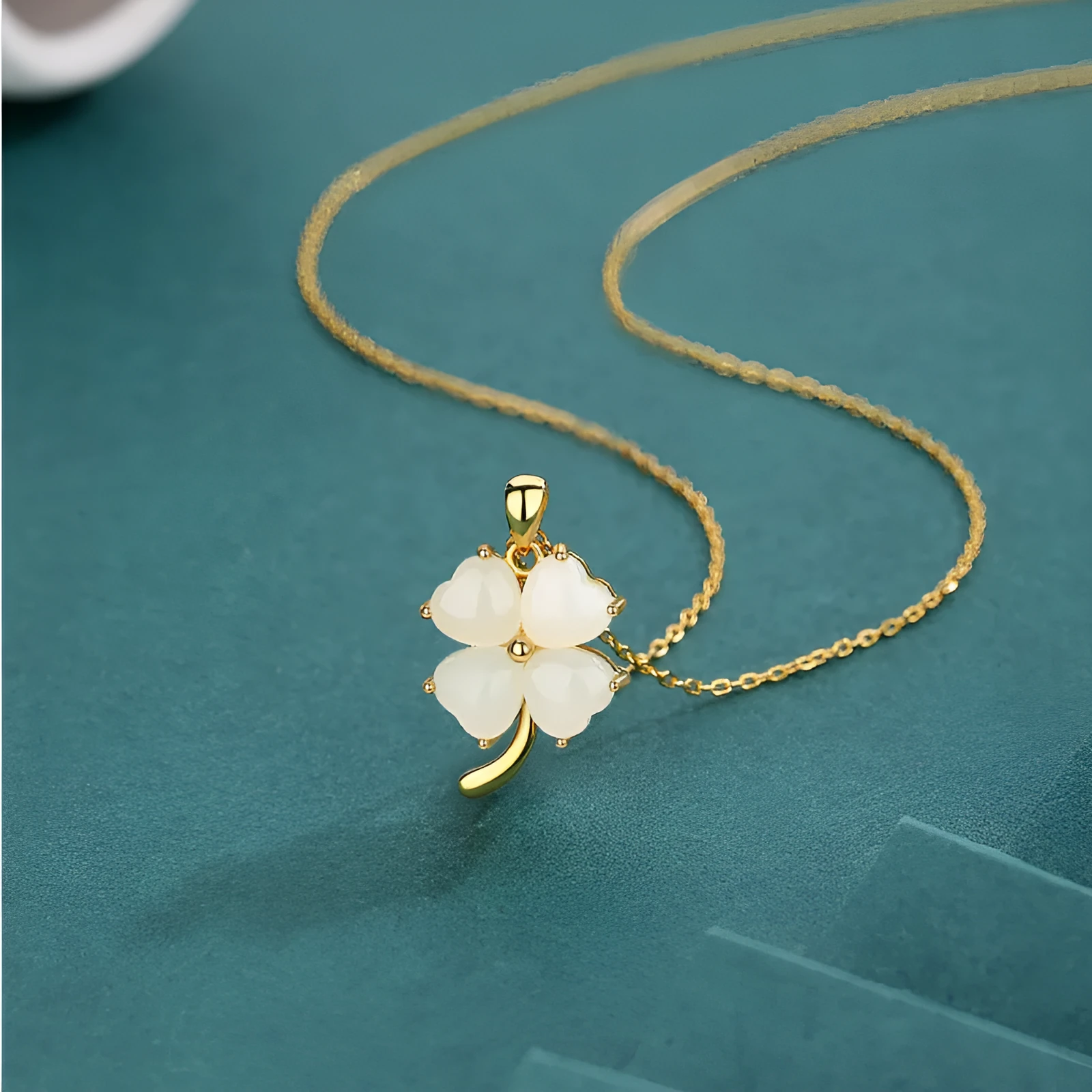 Women's four-leaf clover necklace with Hetian jade pendant on an adjustable sterling silver chain.