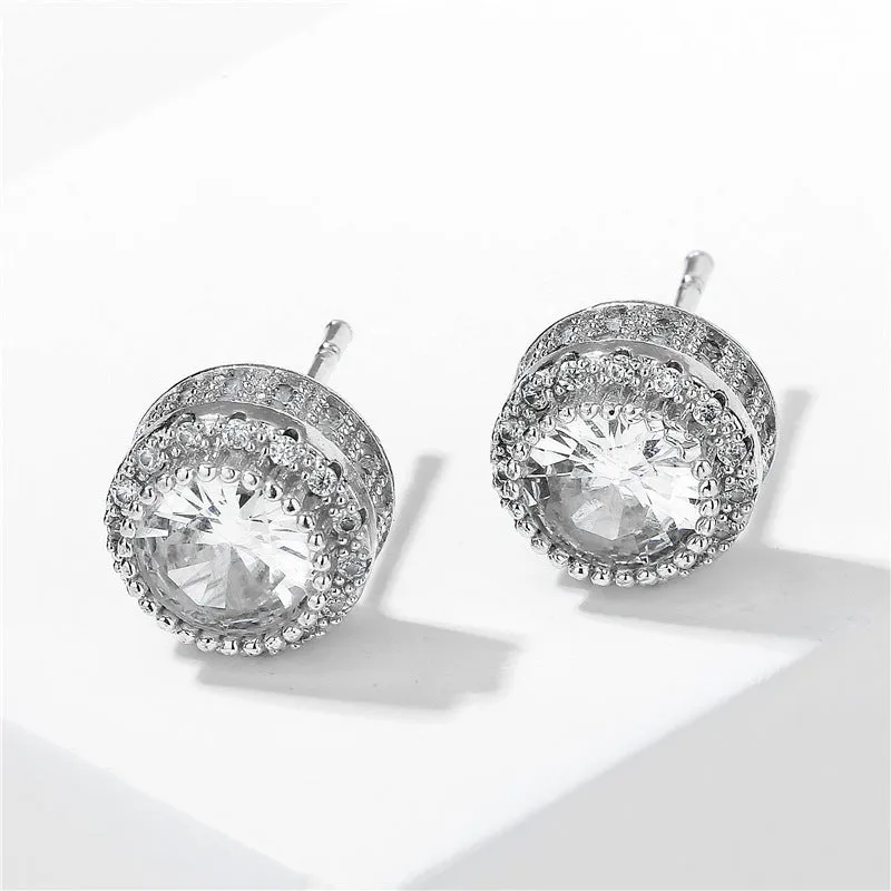 Round copper stud earrings with inlaid zircon in gold tone on white background