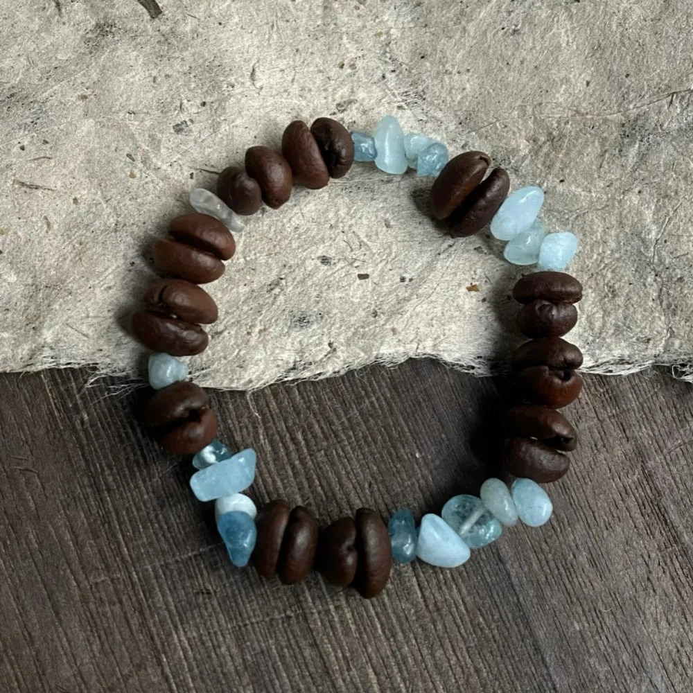 Handmade coffee bean bracelet with 16mm geometric charm showing colour variations