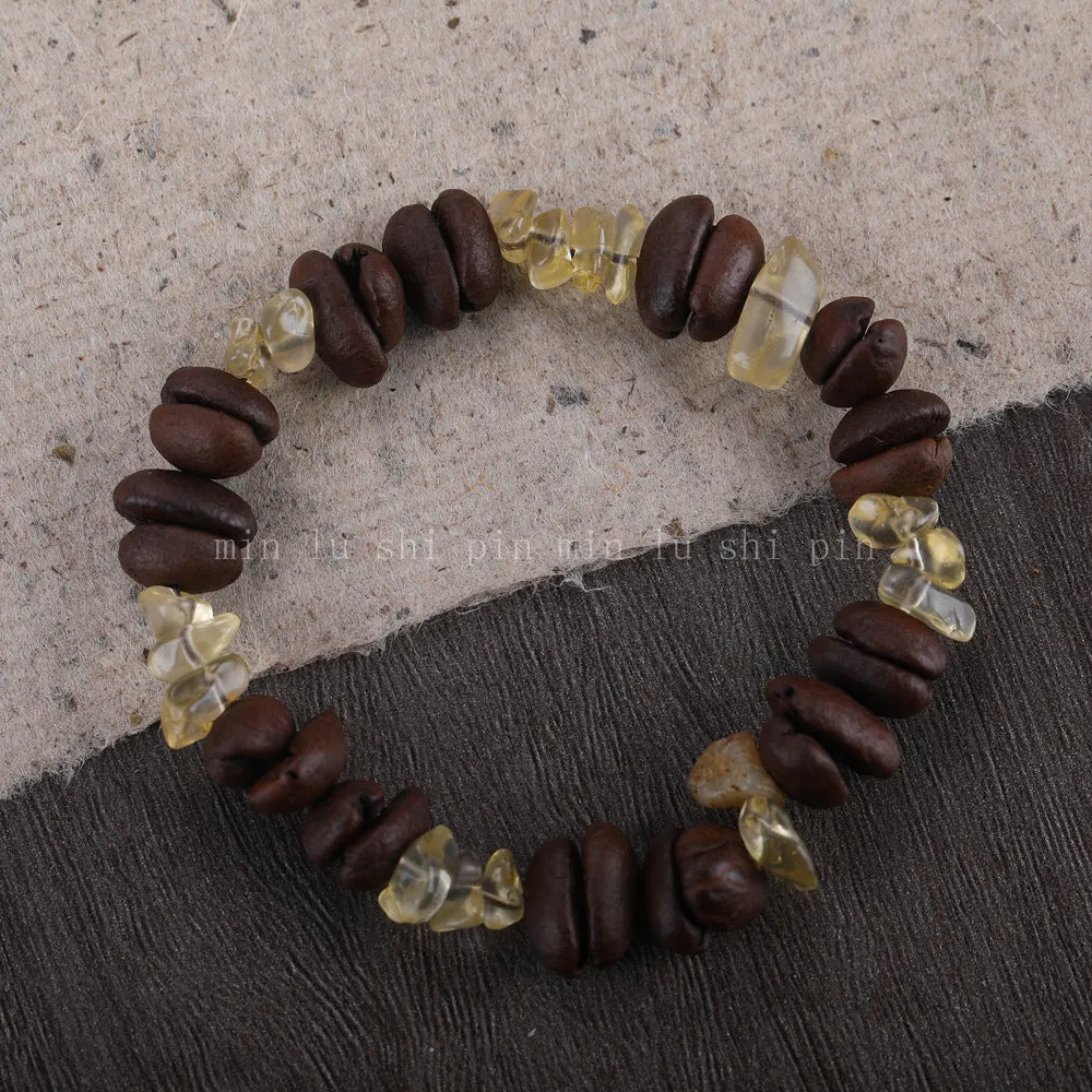 Handmade coffee bean bracelet with 16mm geometric charm showing colour variations