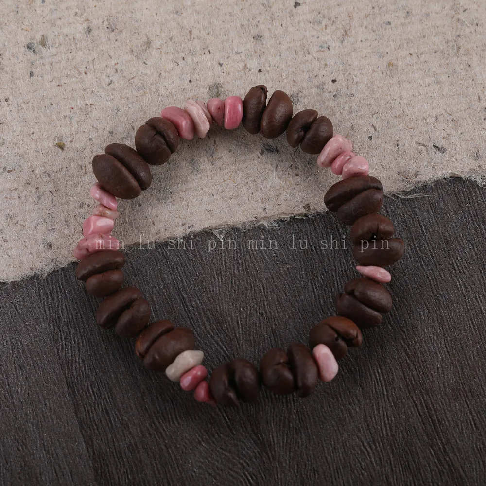 Handmade coffee bean bracelet with 16mm geometric charm showing colour variations