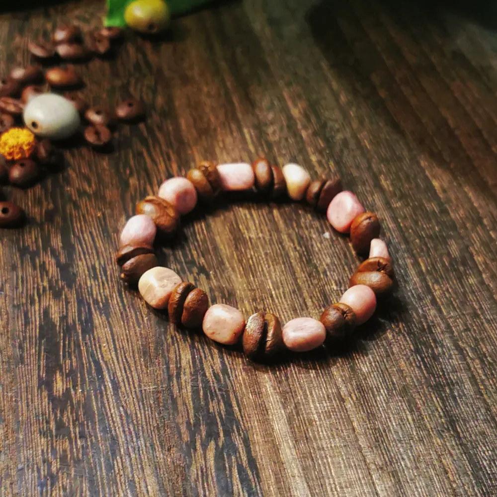 Handmade coffee bean bracelet with 16mm geometric charm showing colour variations