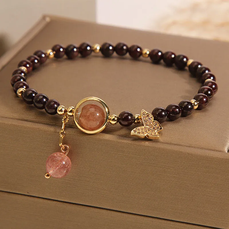 Black butterfly pendant bracelet with stone construction and red rock elements