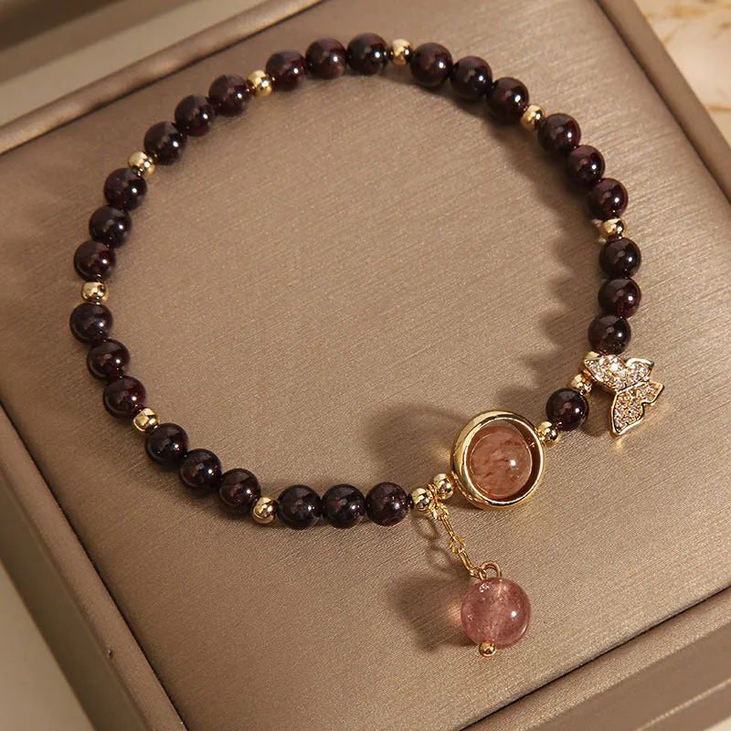 Black butterfly pendant bracelet with stone construction and red rock elements