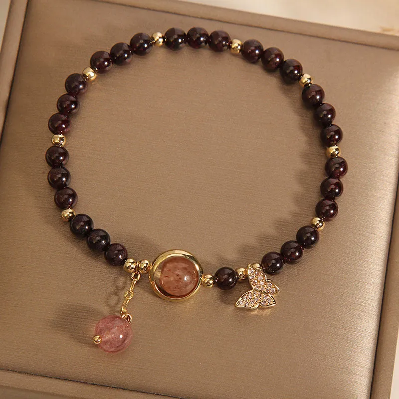 Black butterfly pendant bracelet with stone construction and red rock elements