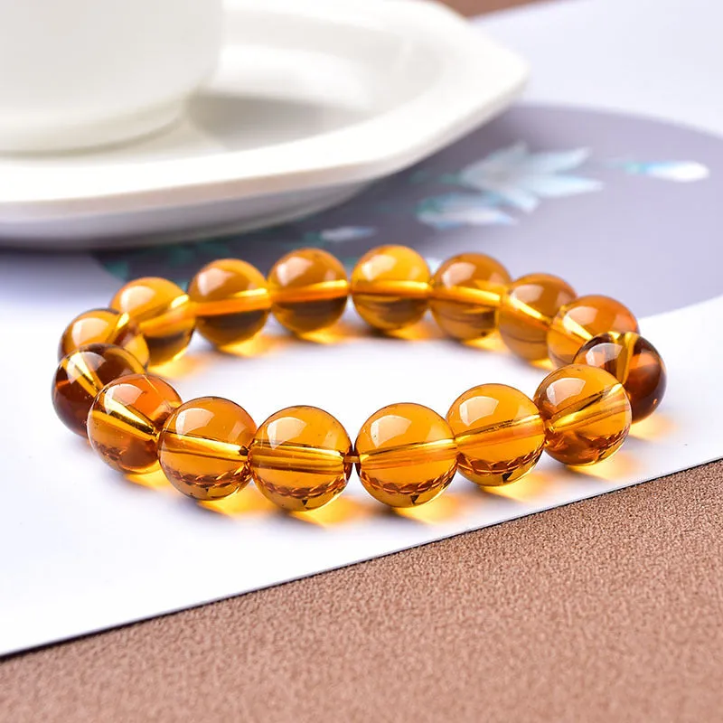 Geometric glass bead bracelet in obsidian, amethyst, citrine, or white crystal on a white background.