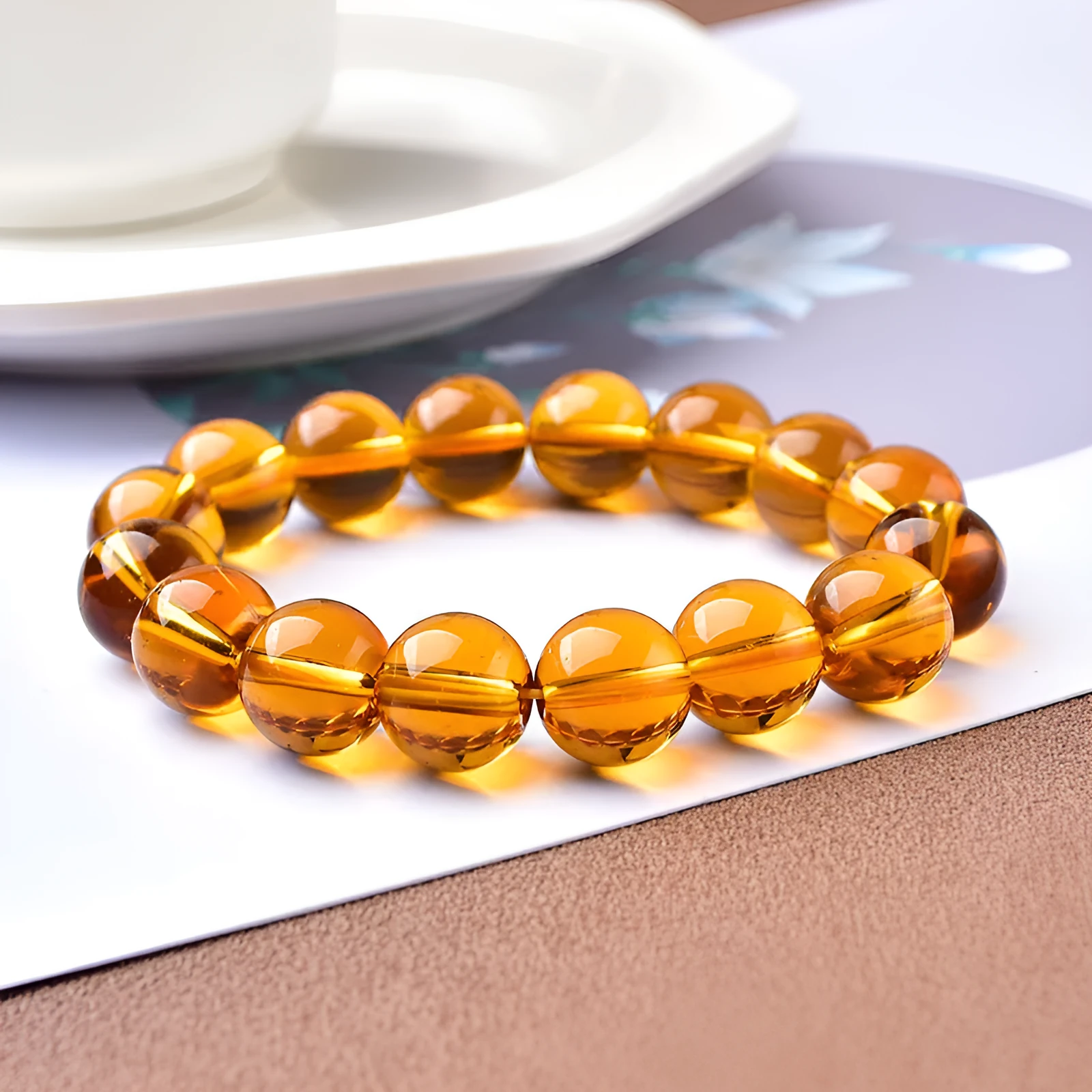 Geometric glass bead bracelet in obsidian, amethyst, citrine, or white crystal on a white background.