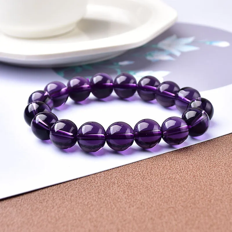 Geometric glass bead bracelet in obsidian, amethyst, citrine, or white crystal on a white background.