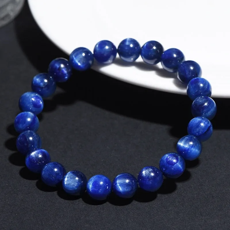Natural blue crystal ball bracelet with geometric shape and Ruyi design on a white background.