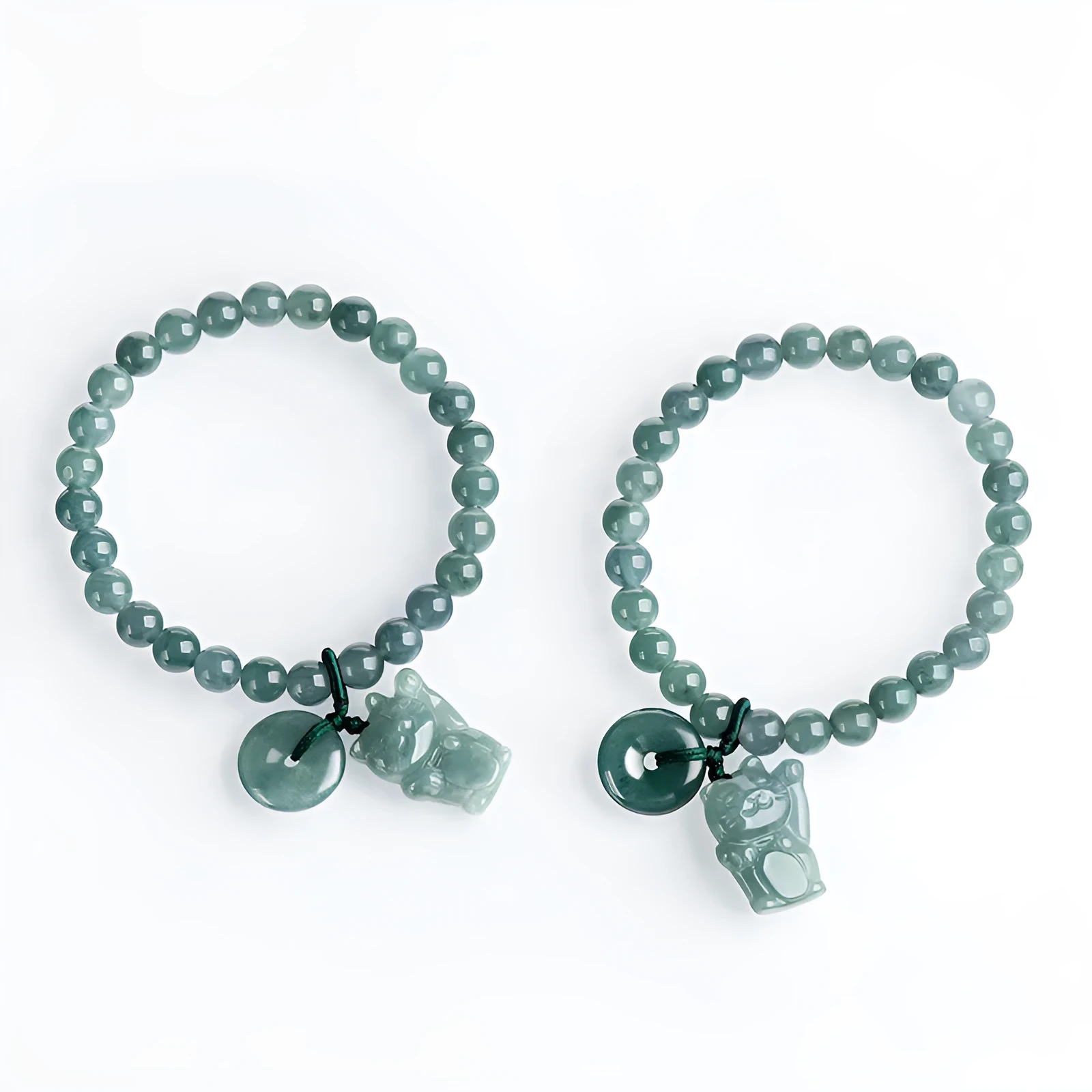 Hand woven bracelet with natural emerald beads and blue water lucky cat charm on a white background