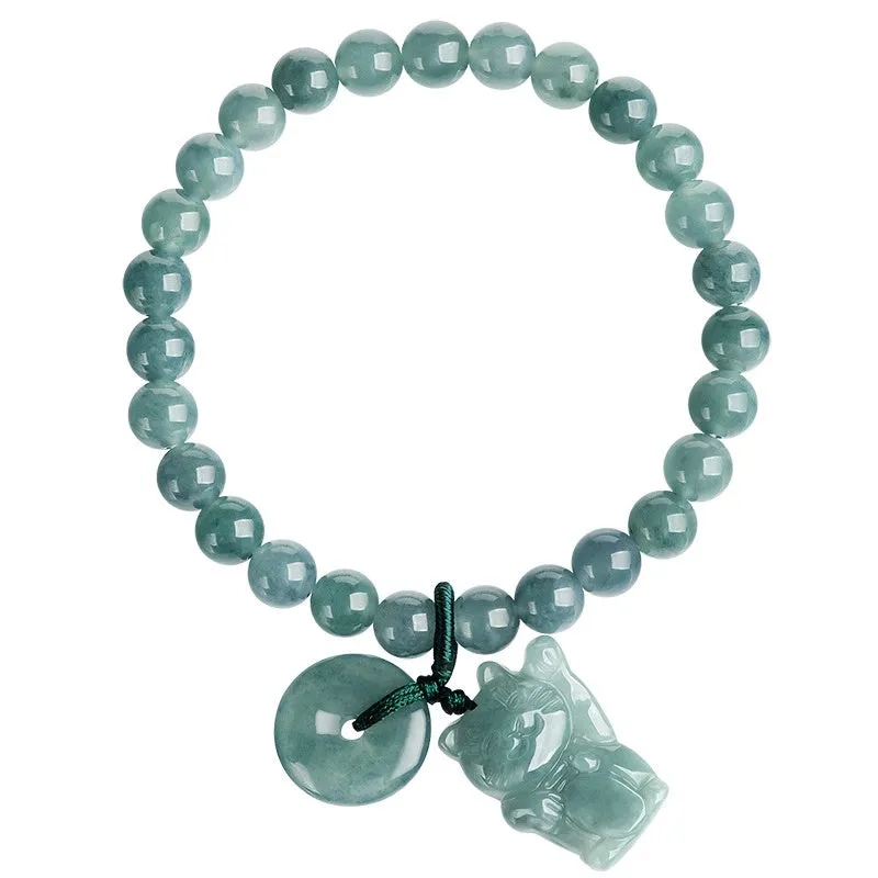Hand woven bracelet with natural emerald beads and blue water lucky cat charm on a white background