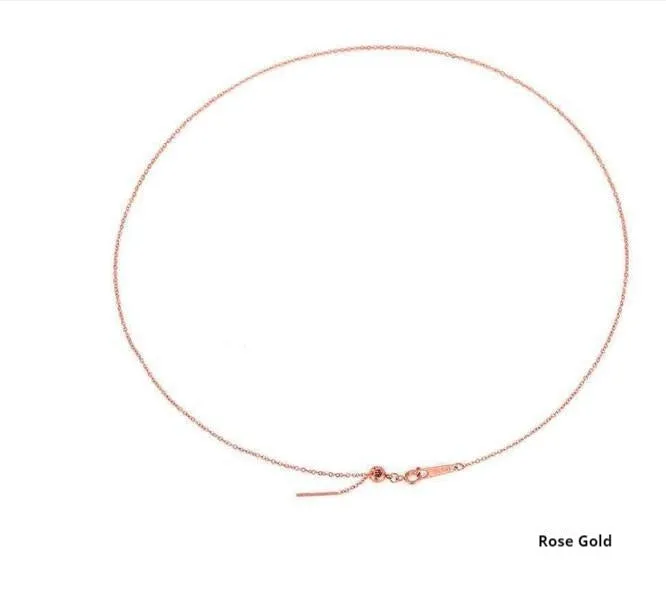 Stainless steel necklace with a U-shaped pendant on a chain, shown in steel, gold, and rose gold colour options.
