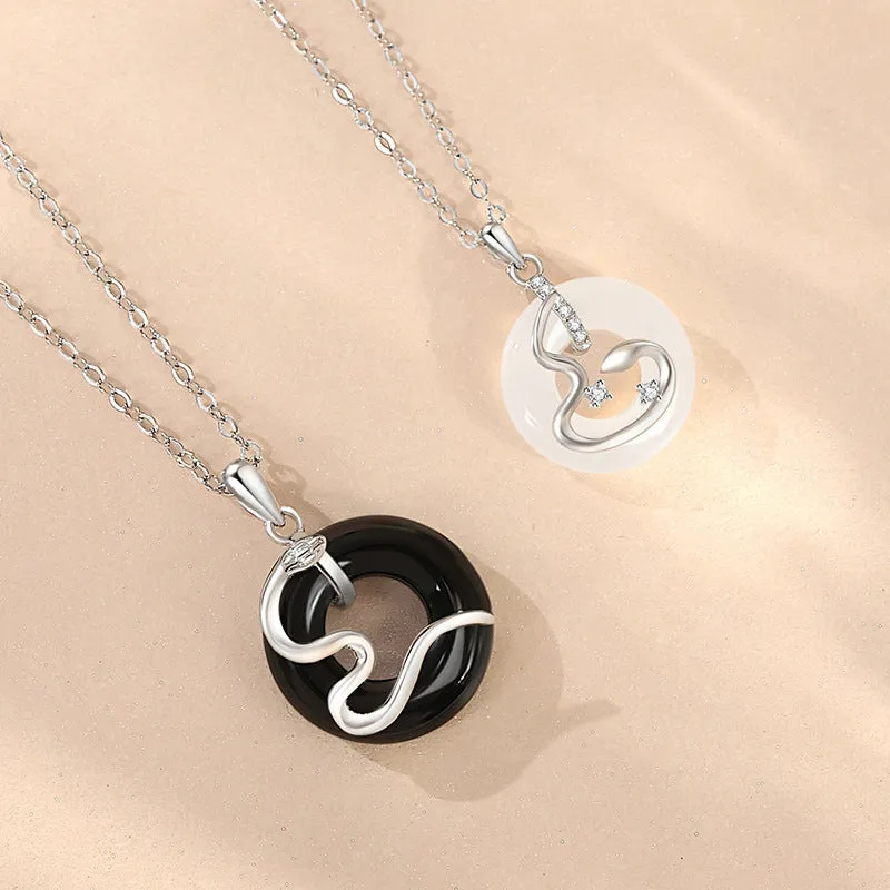 925 sterling silver snake couple necklace with Peace buckle on black background