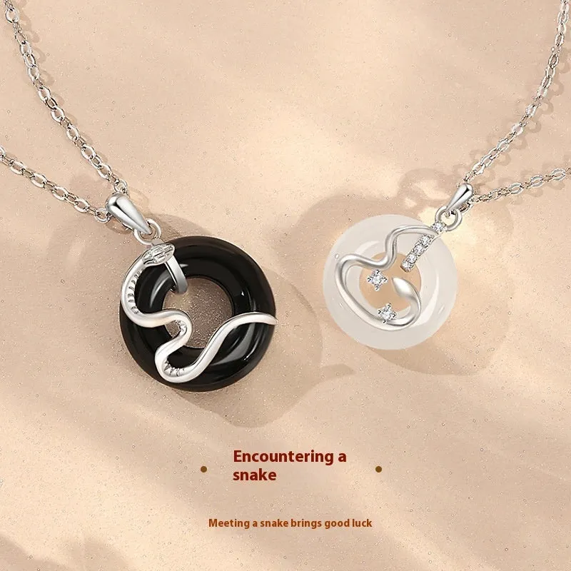 925 sterling silver snake couple necklace with Peace buckle on black background