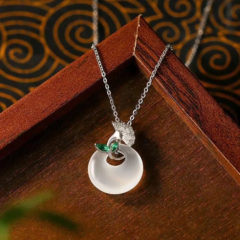 White ginkgo leaf pendant necklace with mixed gem inlay on silver electroplated O-ring chain