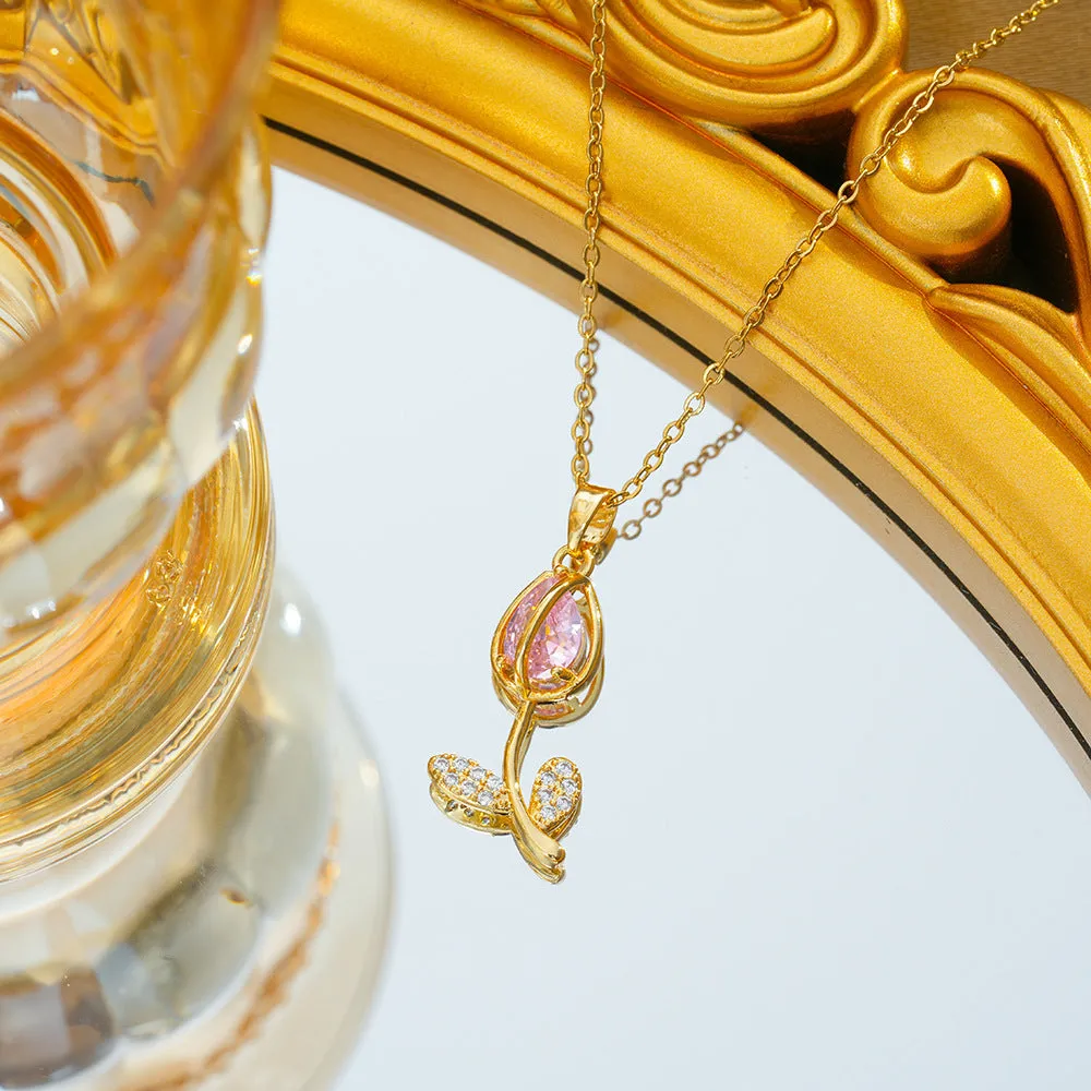 Gold-toned titanium steel necklace with a floral tulip pendant on an O-ring chain.
