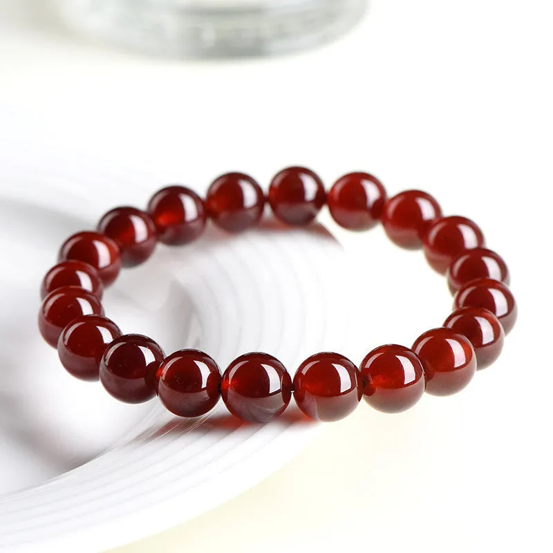 Natural orange red garnet ball bracelet with Ruyi design elements on crystal beads