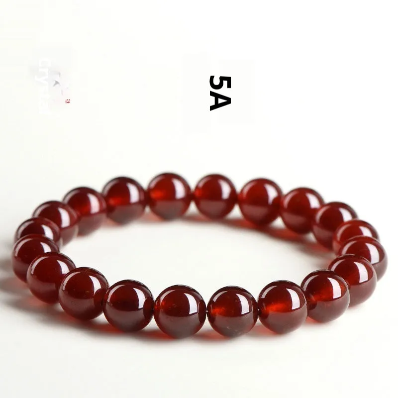 Natural orange red garnet ball bracelet with Ruyi design elements on crystal beads