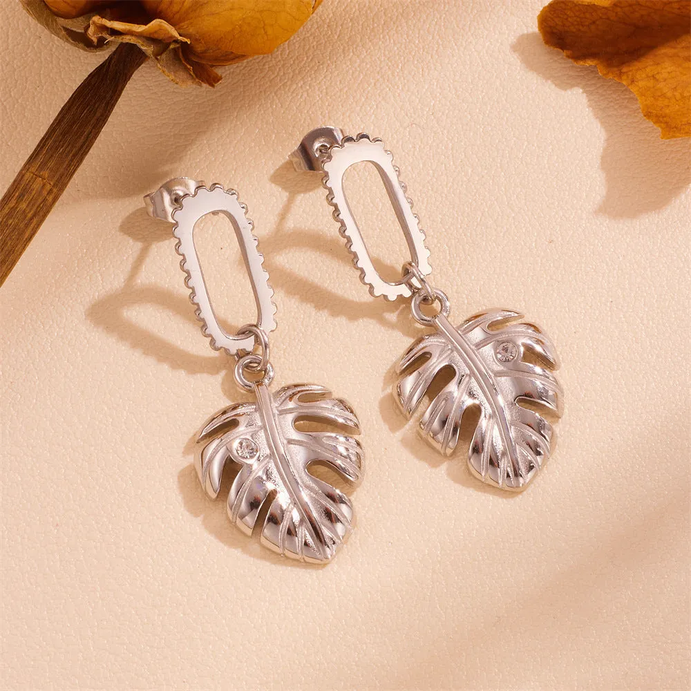 Heart shape titanium steel earrings in gold leaf style on white background