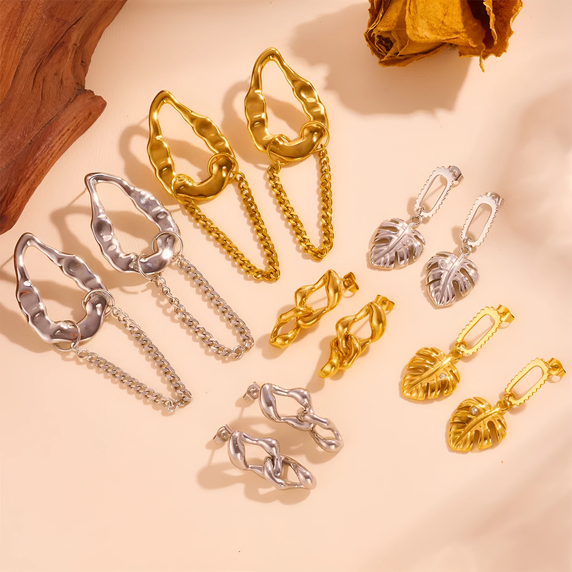 Heart shape titanium steel earrings in gold leaf style on white background