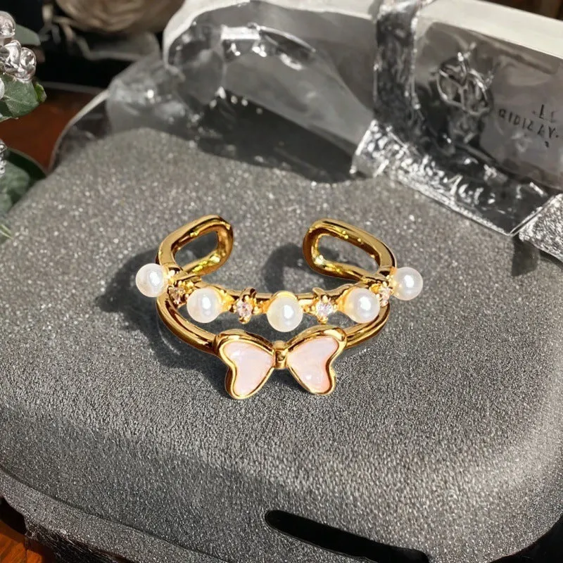 A copper vintage-style ring with a gourd motif, floral and bow designs, inlaid zircon stones, and an adjustable opening.