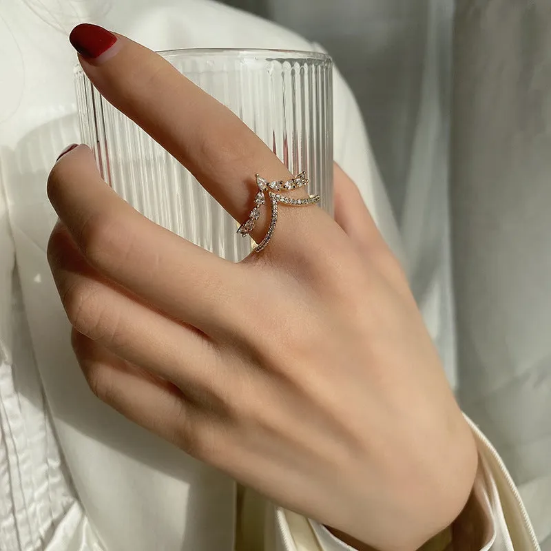 Gold plated copper heart shaped ring with full diamond detailing on white background