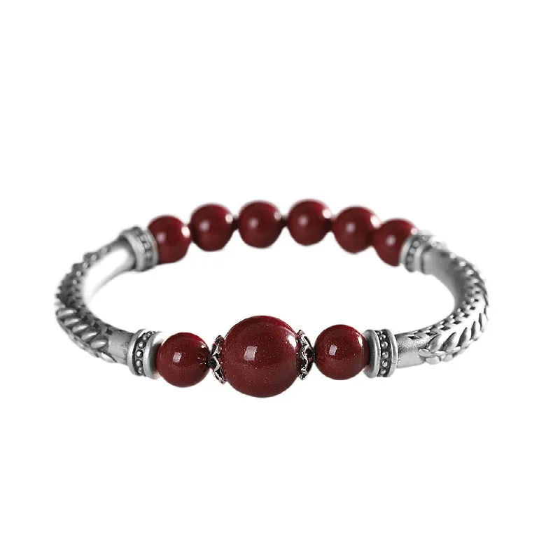 Pure silver 999 cinnabar bracelet with 10mm round retro geometric beads on neutral background