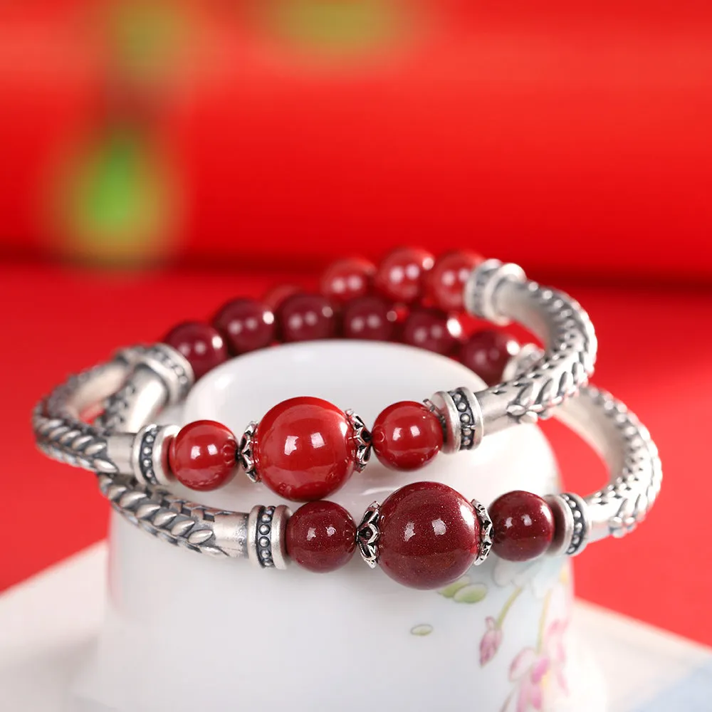 Pure silver 999 cinnabar bracelet with 10mm round retro geometric beads on neutral background
