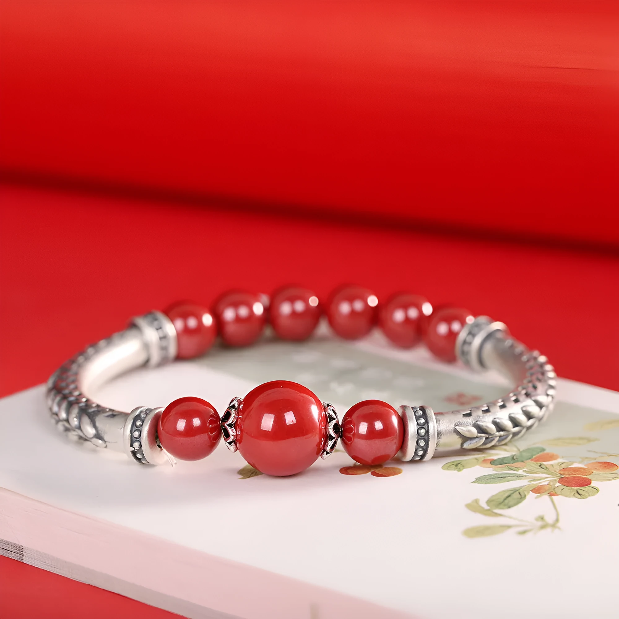 Pure silver 999 cinnabar bracelet with 10mm round retro geometric beads on neutral background