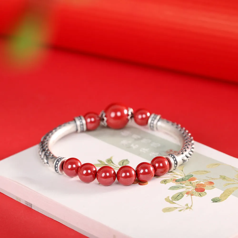 Pure silver 999 cinnabar bracelet with 10mm round retro geometric beads on neutral background