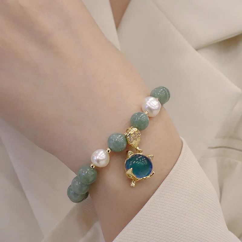 Burma jade warm fox pendant bracelet with temperature-sensitive feature and freshwater pearl accent on white background