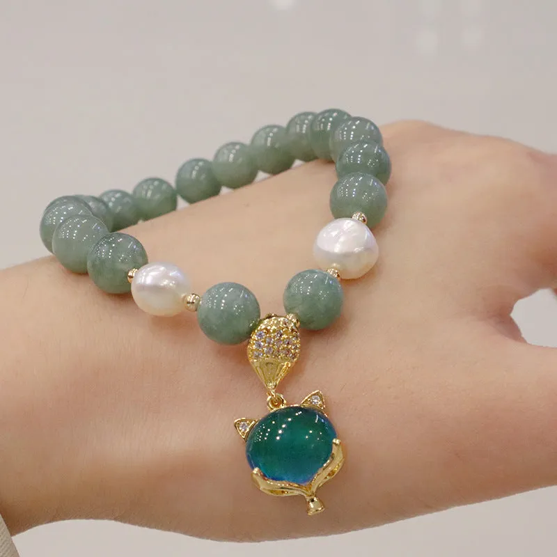 Burma jade warm fox pendant bracelet with temperature-sensitive feature and freshwater pearl accent on white background