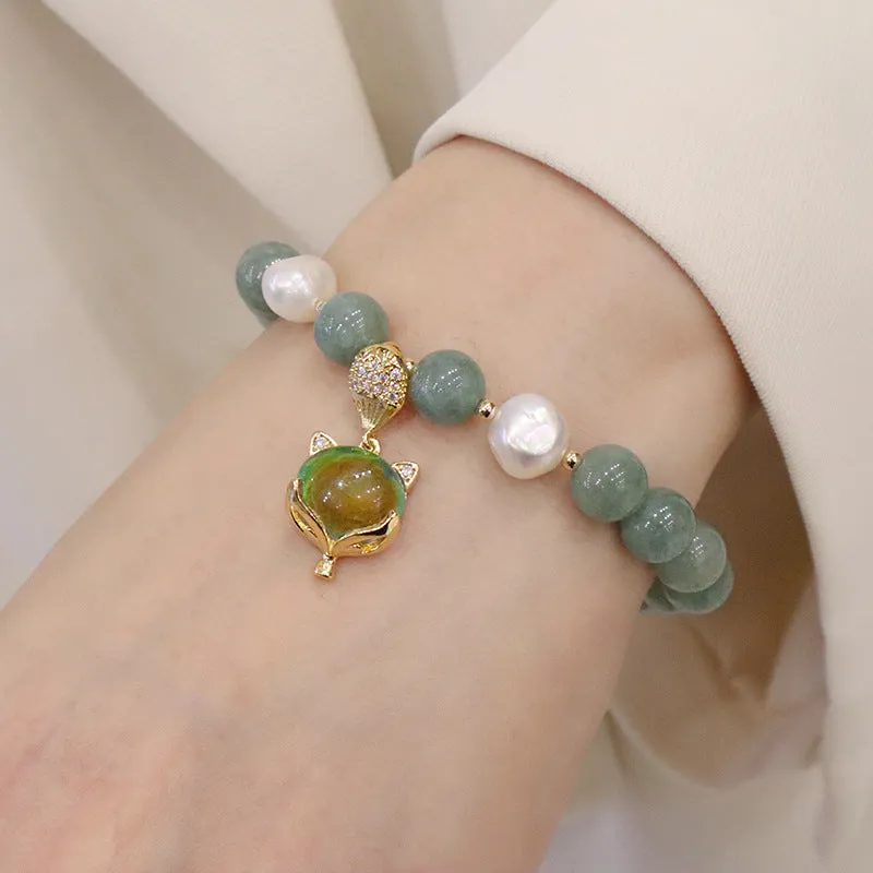 Burma jade warm fox pendant bracelet with temperature-sensitive feature and freshwater pearl accent on white background