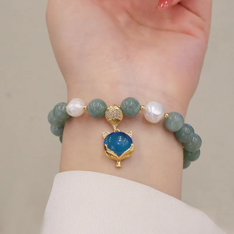 Burma jade warm fox pendant bracelet with temperature-sensitive feature and freshwater pearl accent on white background