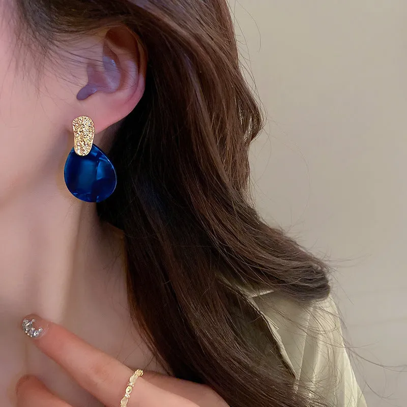 Silver Needle blue acrylic water drop ear studs with pleated texture on white background