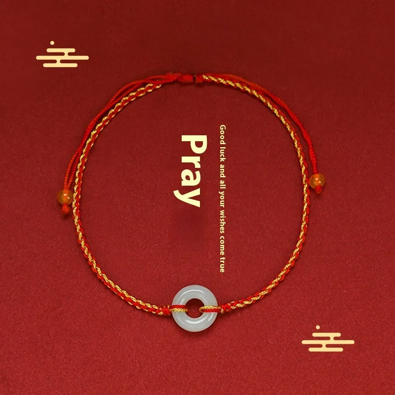 Red rope braided bracelet with natural wave-shaped Hetian jade pendant for Tiger Year birth year, on a neutral background
