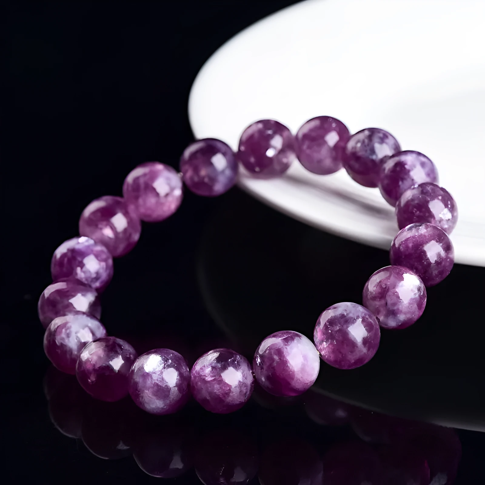 Grandmother crystal bracelet with polished geometric beads in purple on a wrist.