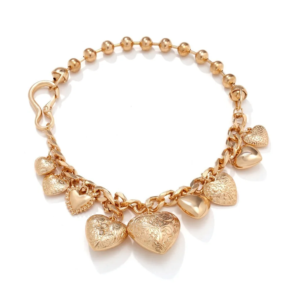 Exaggerated gold heart pendant necklace on a model, showing adjustable chain length.